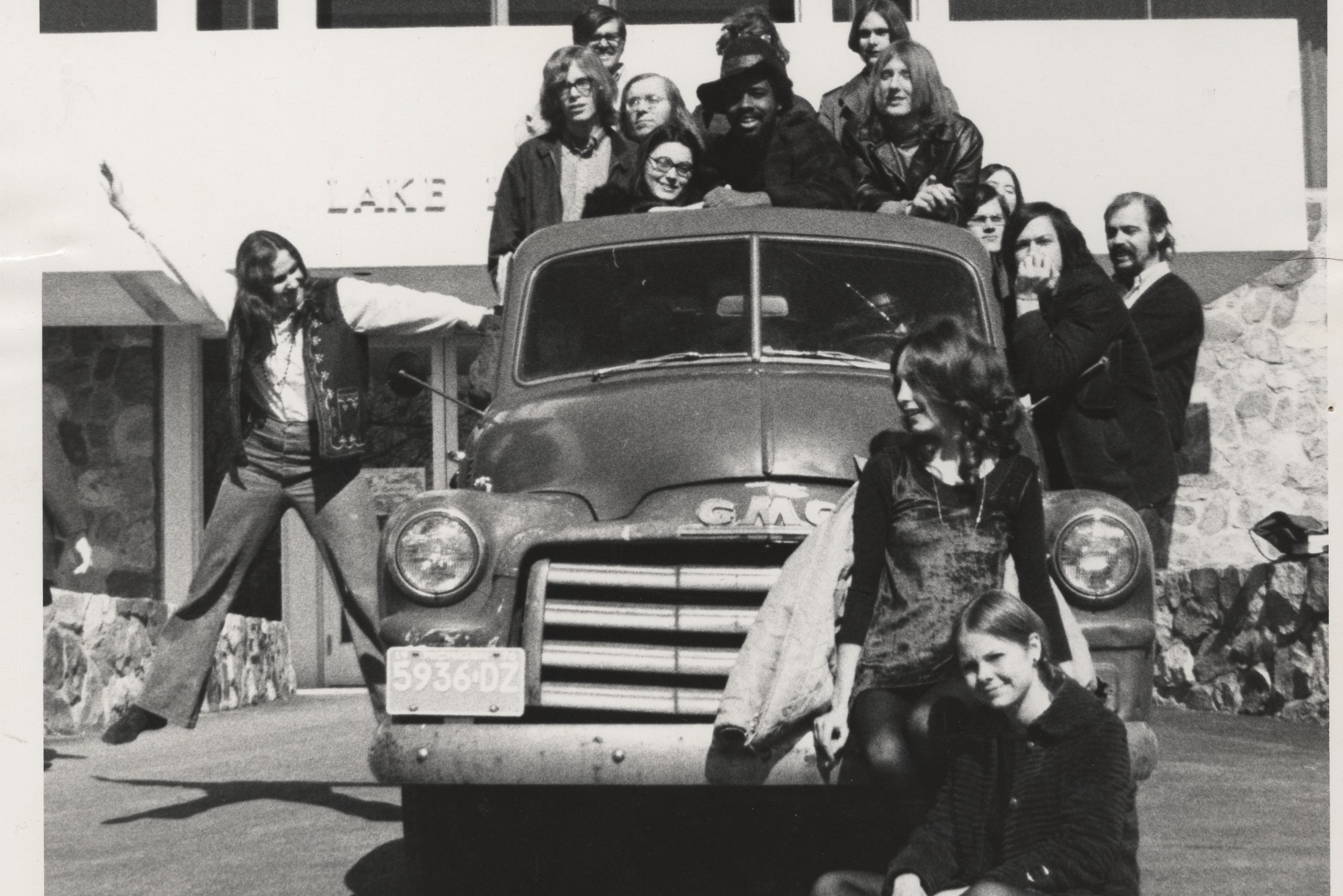 Thomas Jefferson College students posing on truck in front of Lake Huron Hall. Keep on Truckin' poster was based on this series of images.
